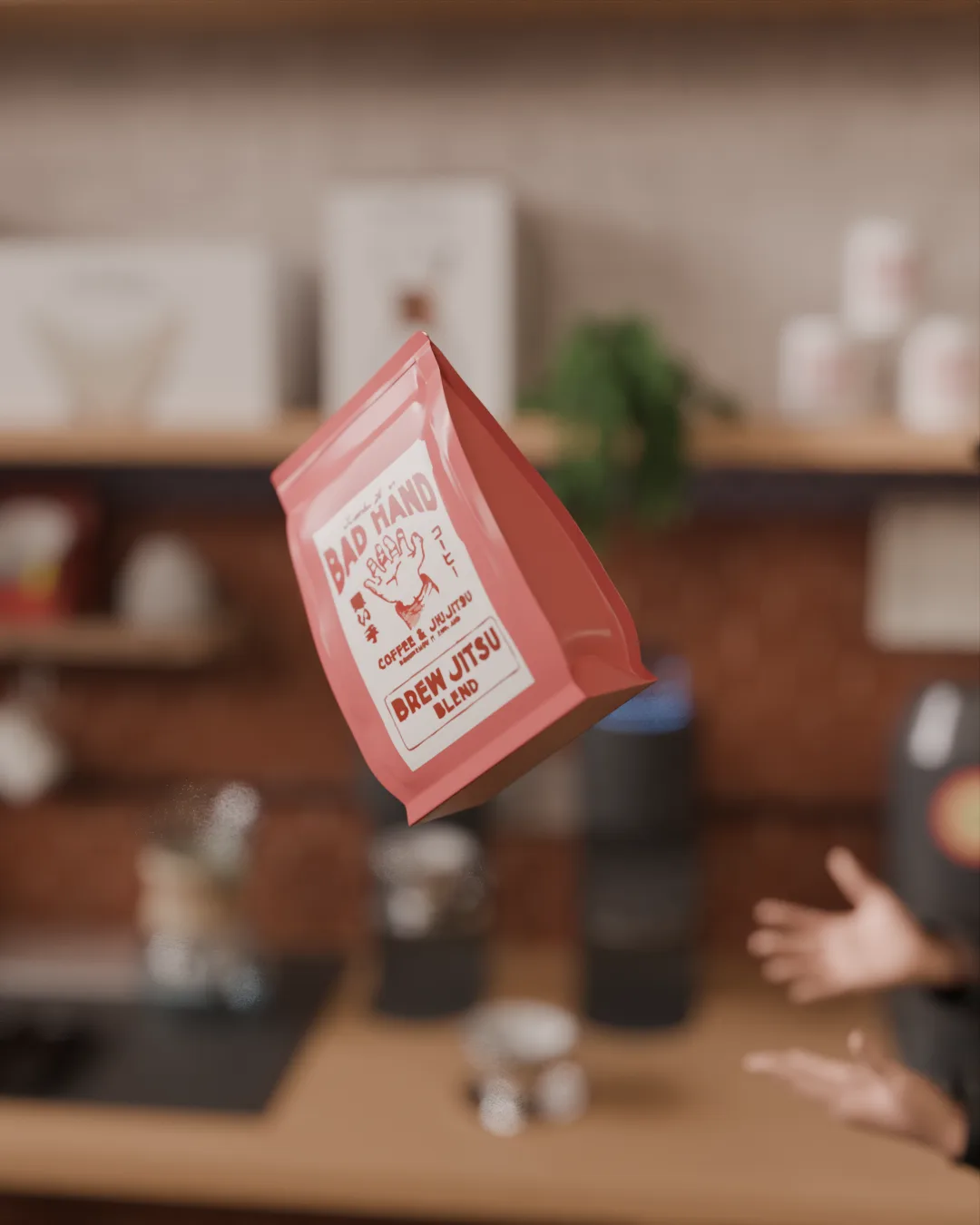 Red 'Bad Hand' coffee bag tossed mid-air, reaching hands blurred against the shop counter.
