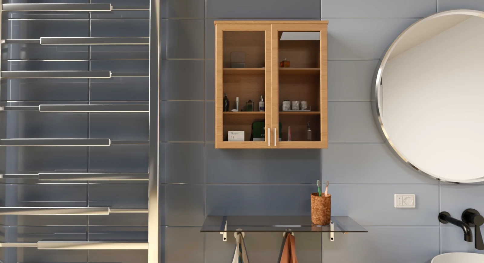 A glass-fronted wood cabinet holds toiletries on open shelves, beside a round mirror on blue tiled wall.