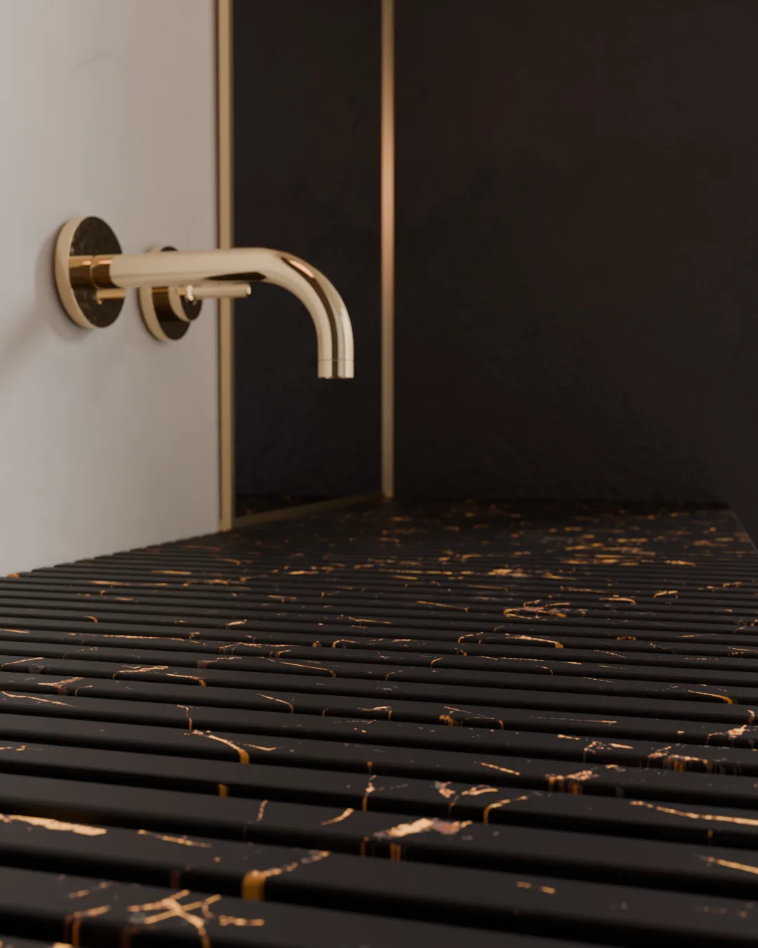 A brushed gold tap against a black and gold marbled, fluted surface.
