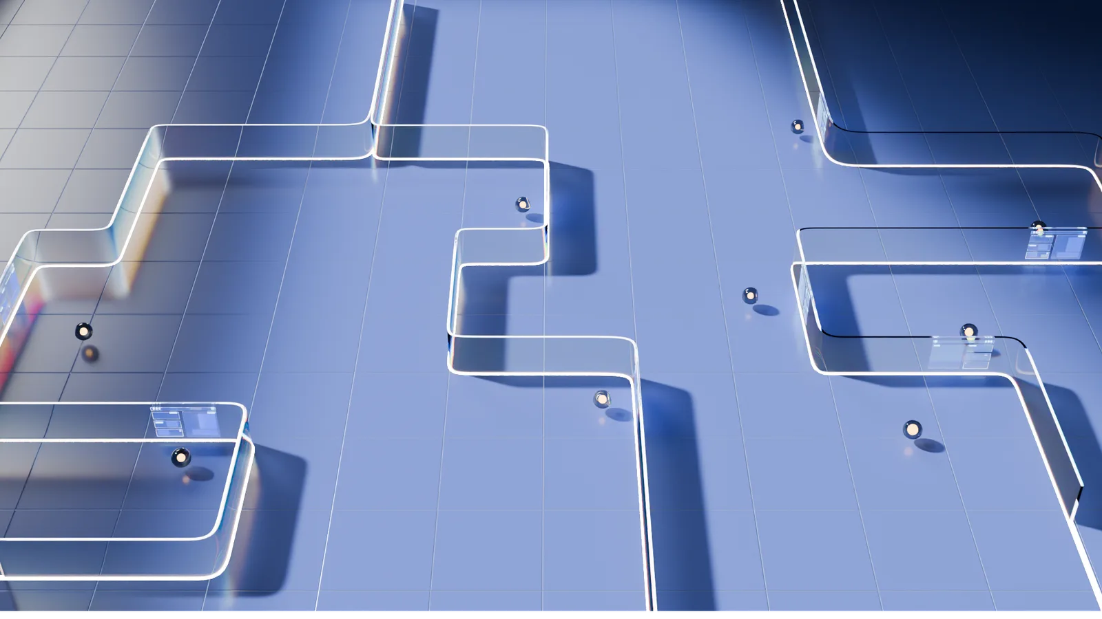 A wider aerial view of the same glass-rail maze, more chrome spheres and small screen panels across the blue grid.